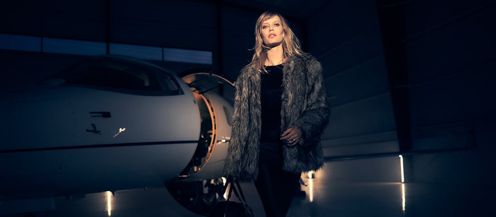 A woman is showing leaving a private jet to align with the exclusivity of 2025 Lincoln Black Label