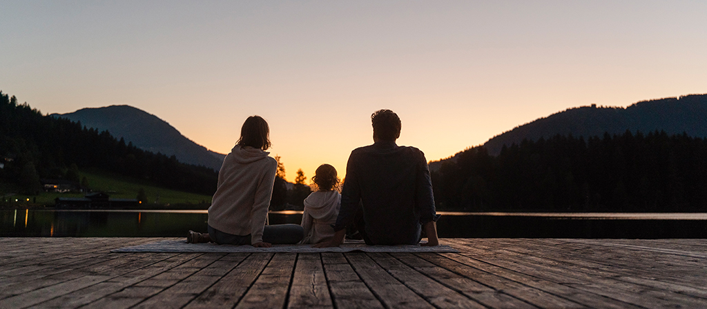 A family enjoys a sunset together