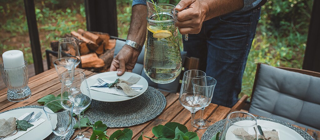 A dining table is being set to replicate the inspiration for the Lincoln Black Label invitation theme