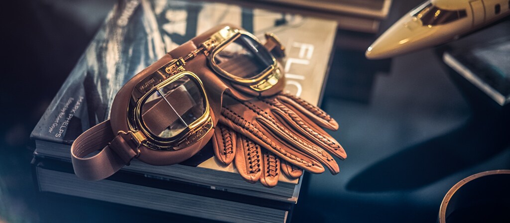 Eye goggles and leather gloves speak to the inspiration of the Flight theme