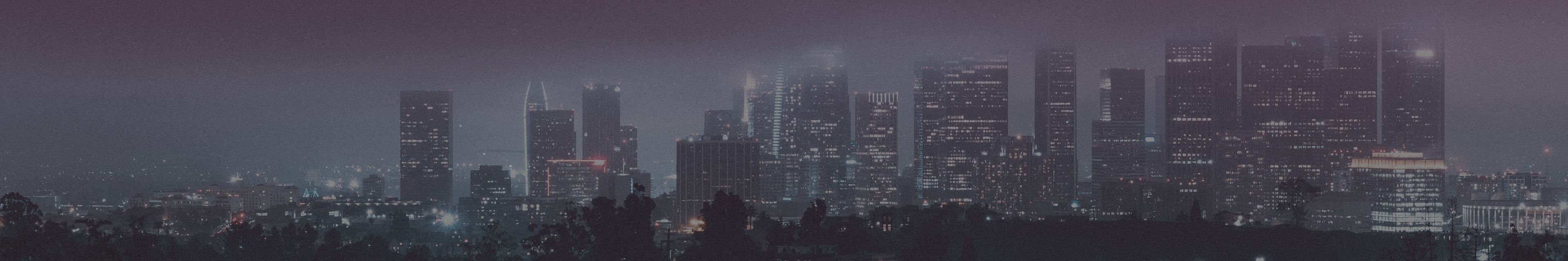 Panoramic view of a city skyline lit up at night