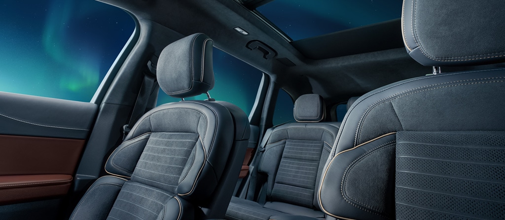 The interior of a 2026 Lincoln Black Label™ Nautilus® SUV in the Aurora interior highlighting the first and second row seating