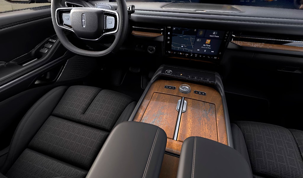 Khaya real-wood appliqué of the Invitation theme on the center console of a 2026 Lincoln Black Label Navigator® SUV