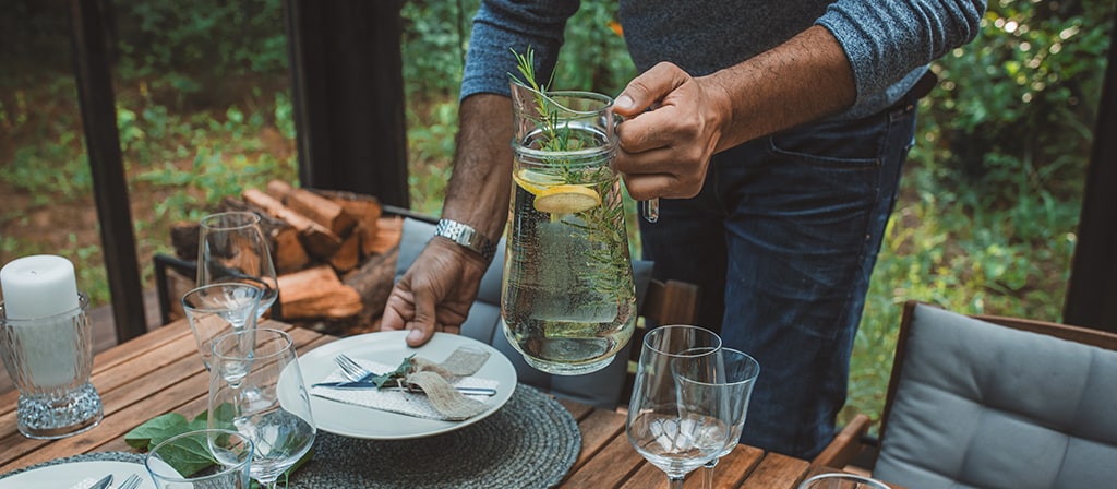 A person sets a dining table to reflect the spirit of the 2026 Lincoln Black Label™ Invitation theme