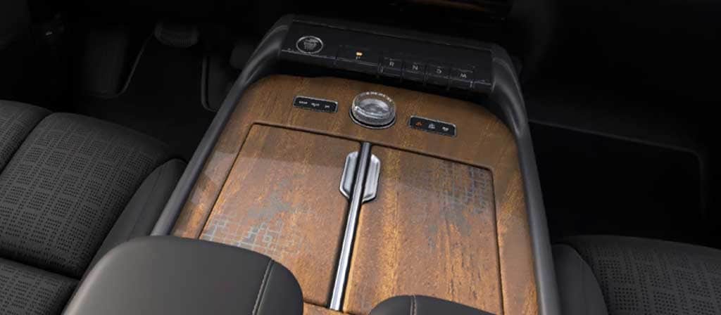 Khaya real-wood appliqué of the Invitation theme on the center console of a 2027 Navigator® Lincoln Black Label™ SUV