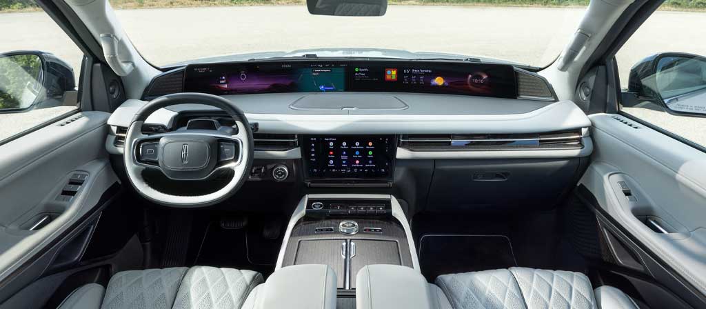 The panoramic display spans the width of a 2027 Lincoln Navigator Black Label™ SUV with the Atmospheric interior theme