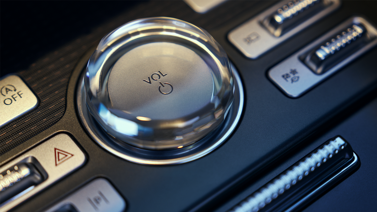 Close-up of the volume control knob and buttons on the Lincoln center console.