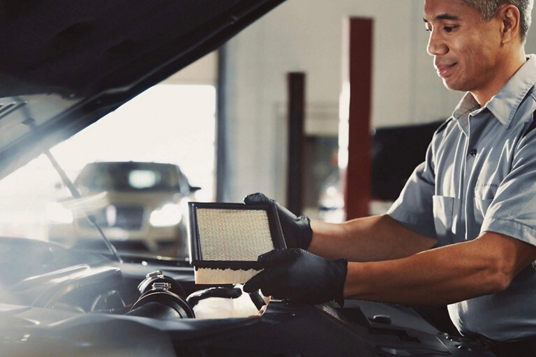 A Lincoln dealership salesperson shows a customer the sleek lines of a Lincoln M K Z
