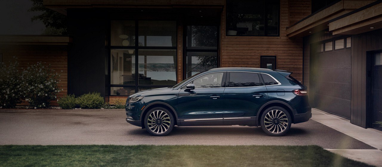 2016 Lincoln MKX on driveway of a luxury home at night