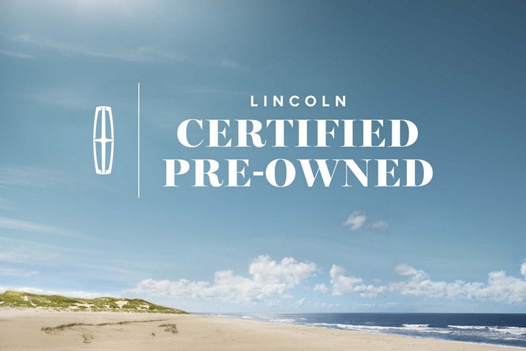 Logo superimposed on image of a beach with bright blue sky