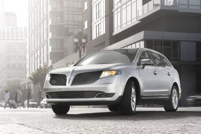 Un Lincoln M K T 2018 en color exterior lingote plateado conduciendo en la ciudad
