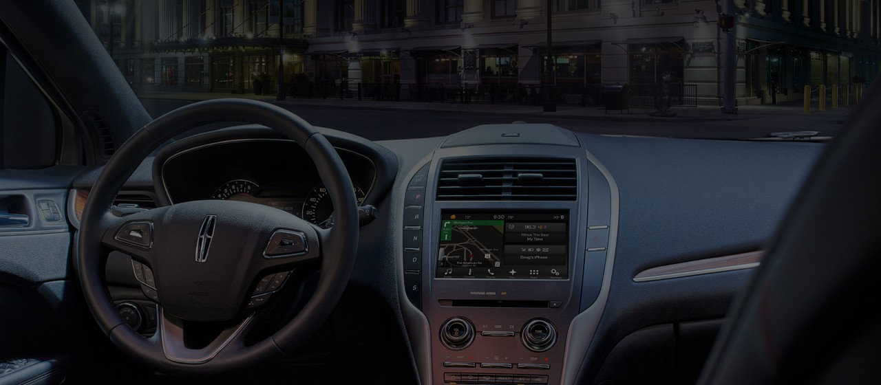 The sleek interior of a Lincoln with SYNC3 on the console.