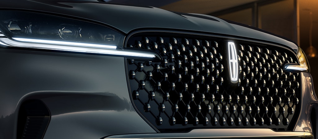 The grille of 2025 Lincoln Black Label Aviator® SUV with glowing Lincoln Star logo in the center