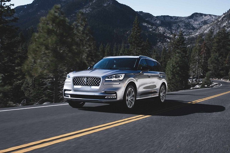 A 2023 Lincoln Aviator® SUV is being driven on a mountain road