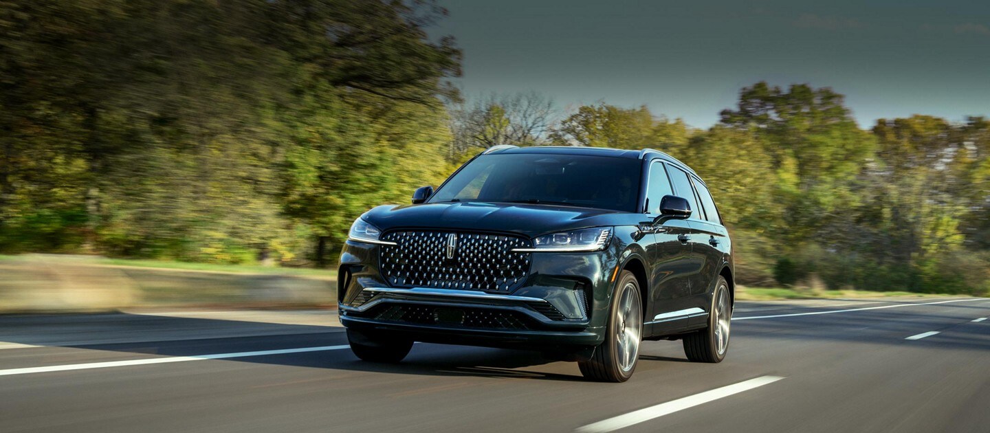 A 2025 Lincoln Aviator® SUV is being driven on a highway