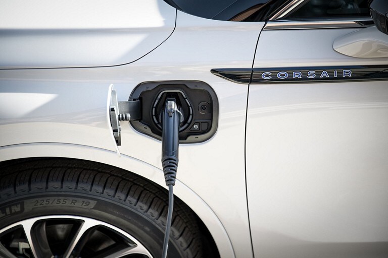 An electric charger is plugged into a 2023 Lincoln Corsair® Grand Touring model’s port near the driver’s door