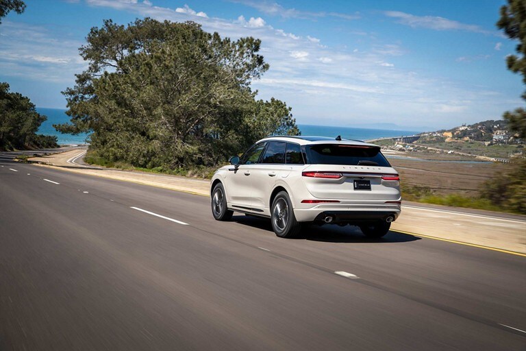 A 2023 Lincoln Corsair® Grand Touring model is being driven along a coastline