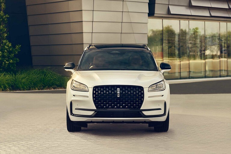 The dazzling LED headlamps of a 2023 Lincoln Corsair® SUV sparkle in the sunlight