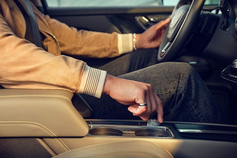The hand of a person driving a 2023 Lincoln Corsair® SUV is shown adjusting the Drive Modes knob