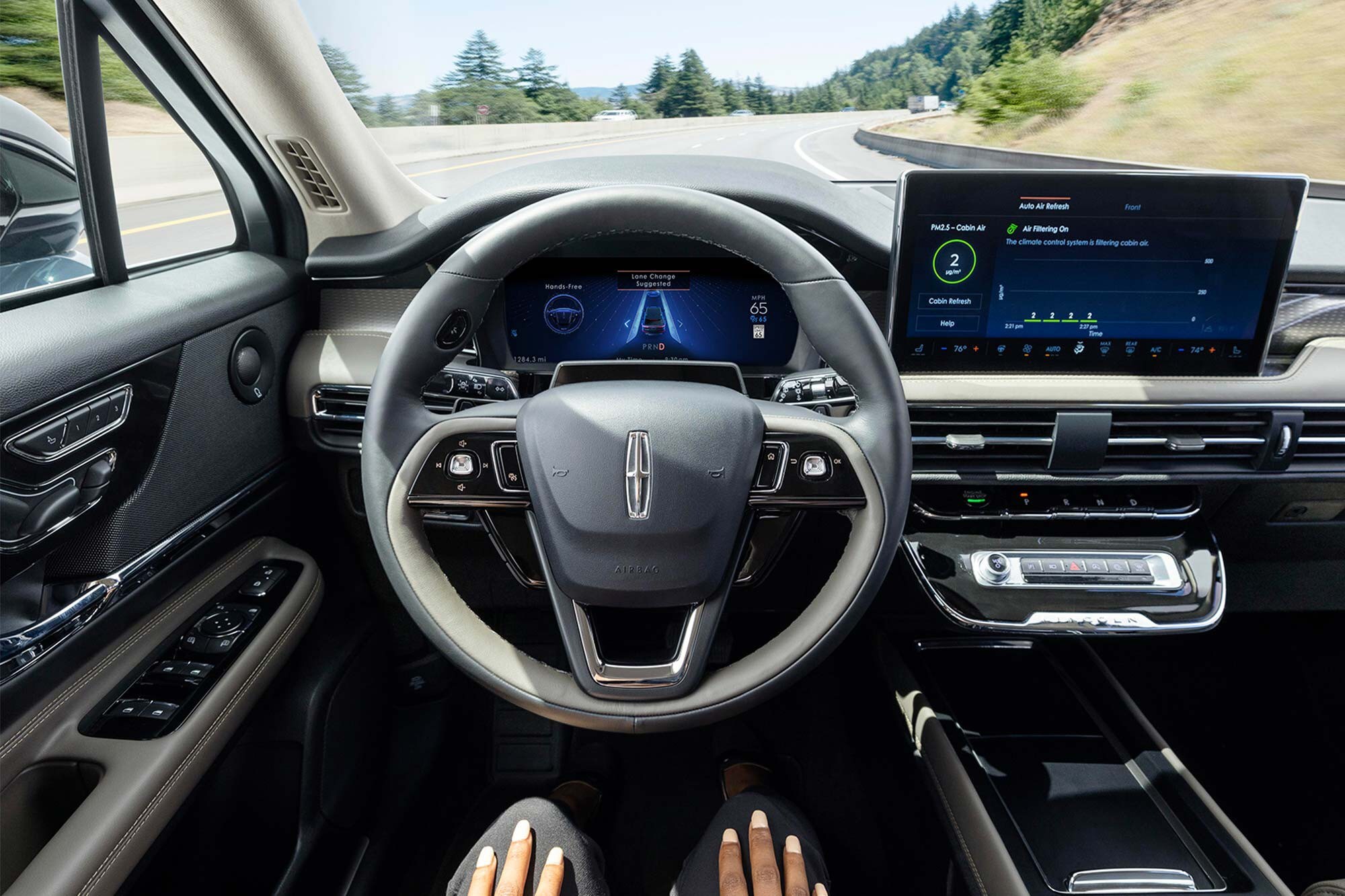 A driver of a 2023 Lincoln Corsair® SUV relaxes with hands-free driving technology engaged.