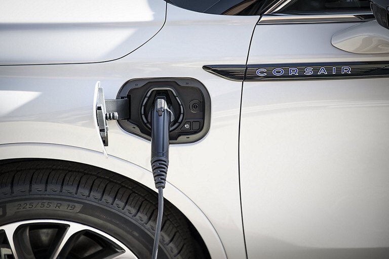 An electric charger is plugged into a 2024 Lincoln Corsair® Grand Touring model’s port near the driver’s door