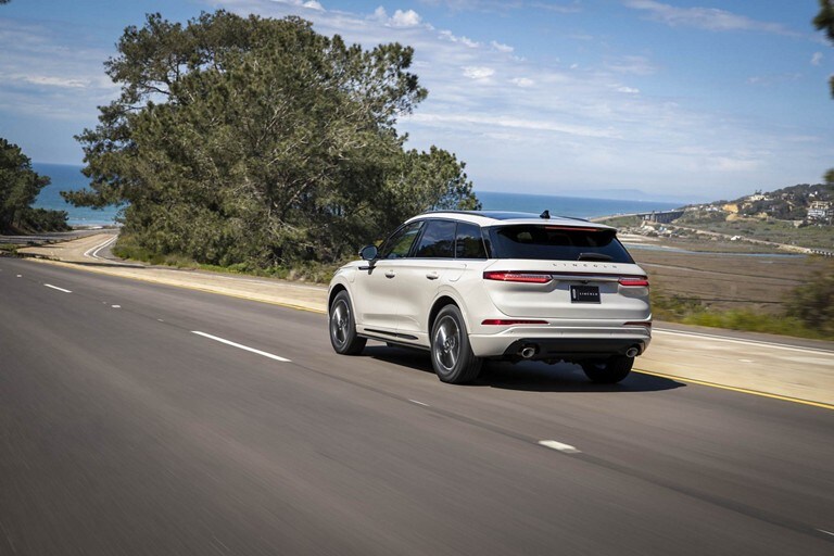 A 2024 Lincoln Corsair® Grand Touring model is being driven along a coastline