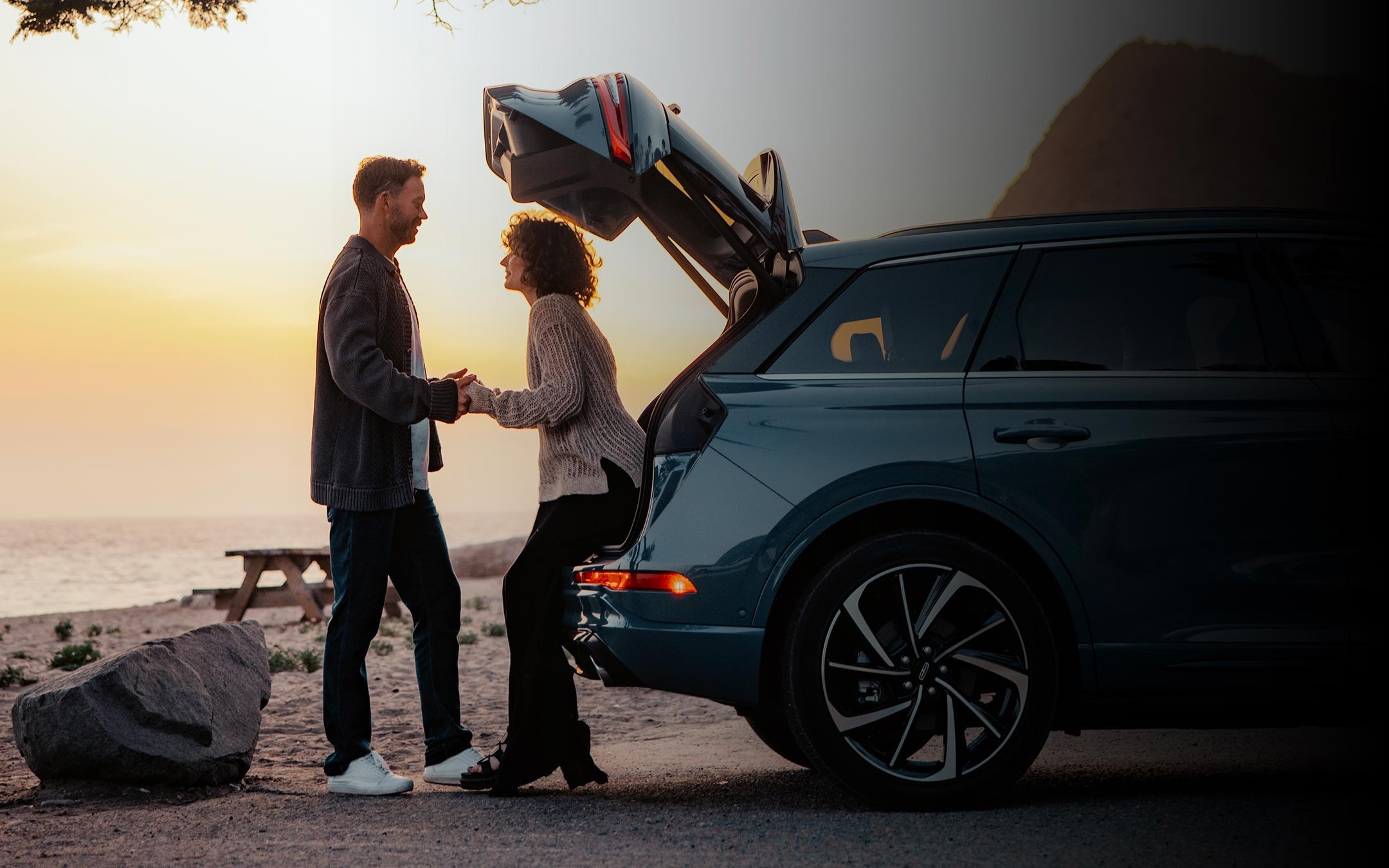 A woman with her hands full makes use of the available hands-free power liftgate