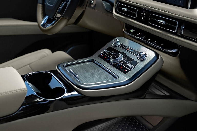 El interior de la cabina delantera de una SUV Lincoln Nautilus® 2023 muestra el diseño de los controles del conductor y el práctico almacenamiento