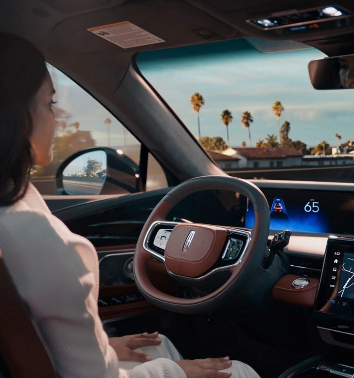 A driver of a 2024 Lincoln Nautilus® SUV is shown using Lincoln BlueCruise hands-free highway driving technology