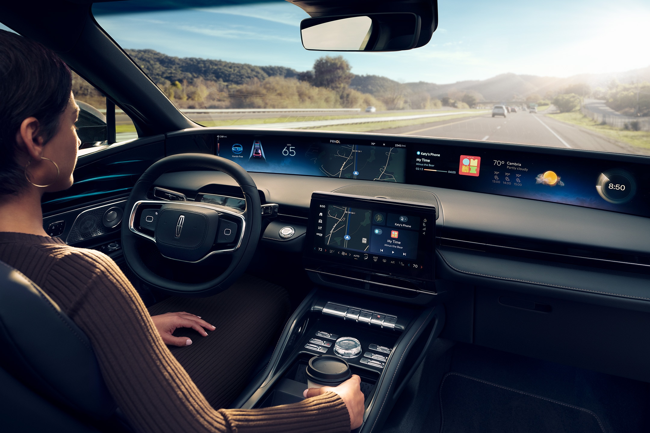 A driver of a 2024 Lincoln Nautilus® SUV is shown using hands-free Lincoln BlueCruise technology on a divided highway.