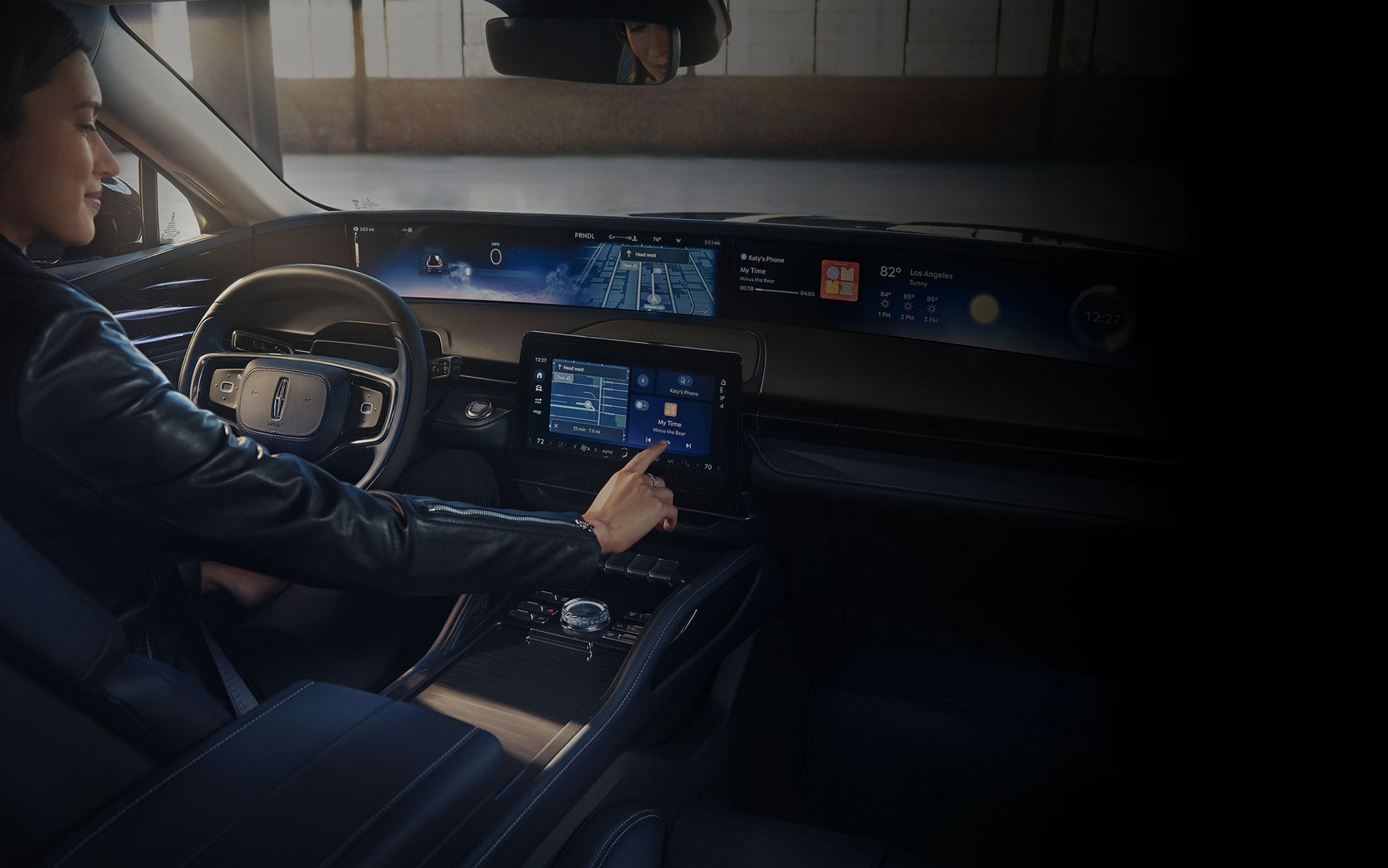 The driver of a 2024 Lincoln Nautilus® SUV interacts with the center-stack touchscreen.