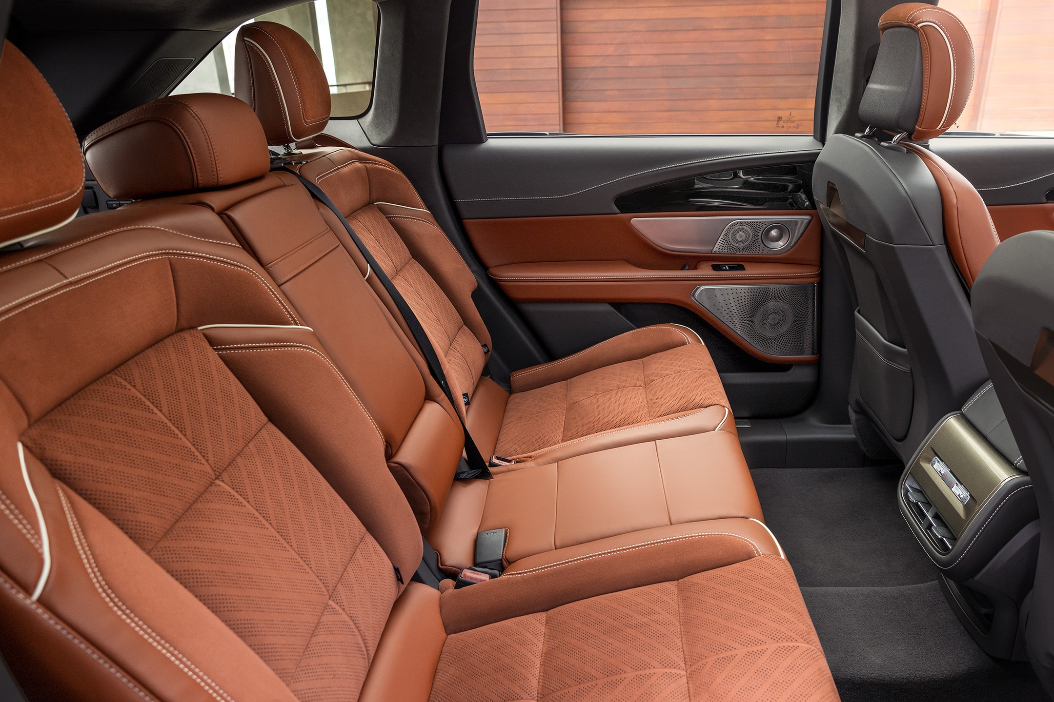 The spacious interior of a 2024 Lincoln Black Label Nautilus® SUV is shown in the redwood interior theme.