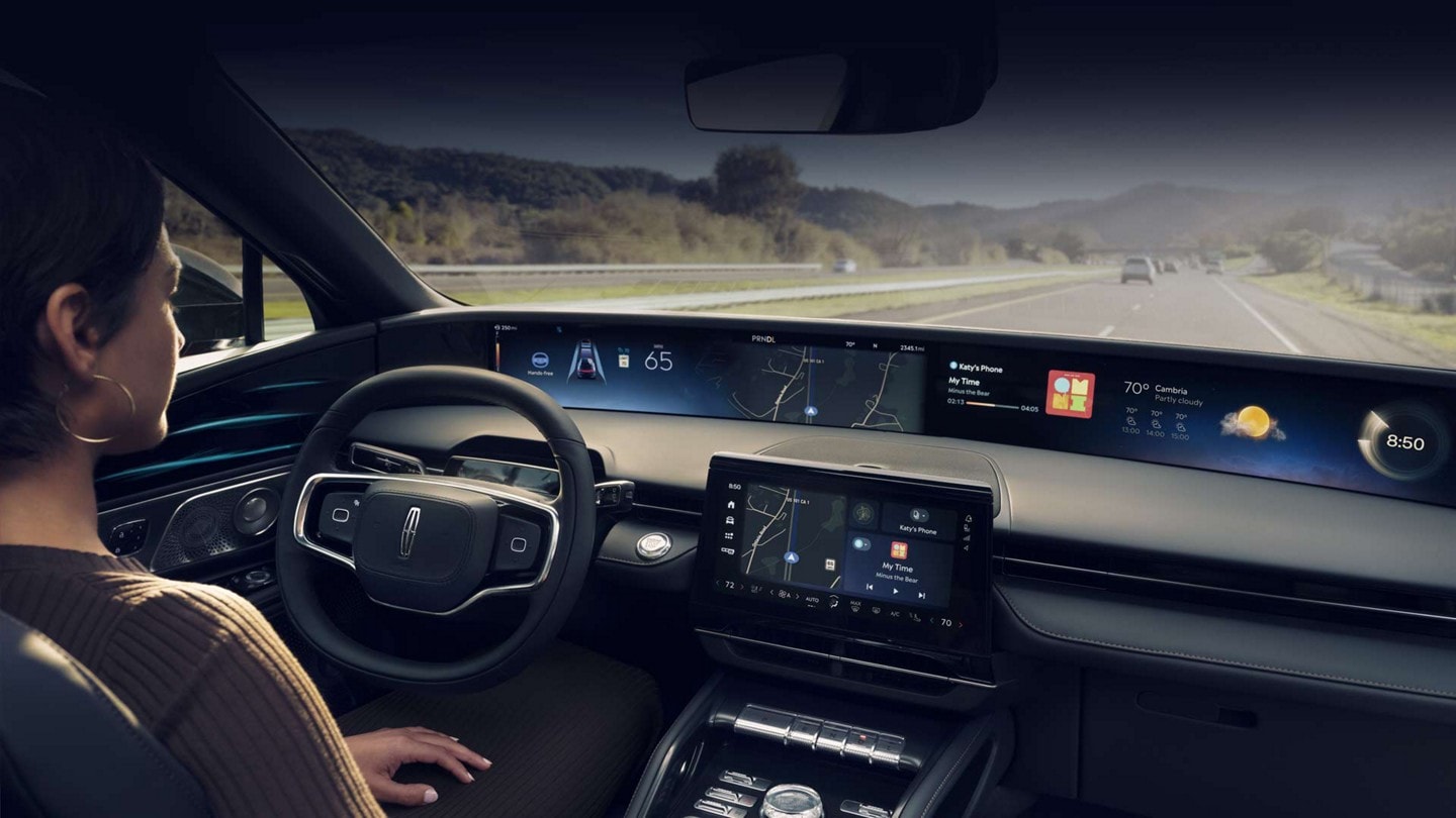 A person uses hands-free highway driving technology on a controlled-access Blue Zone highway