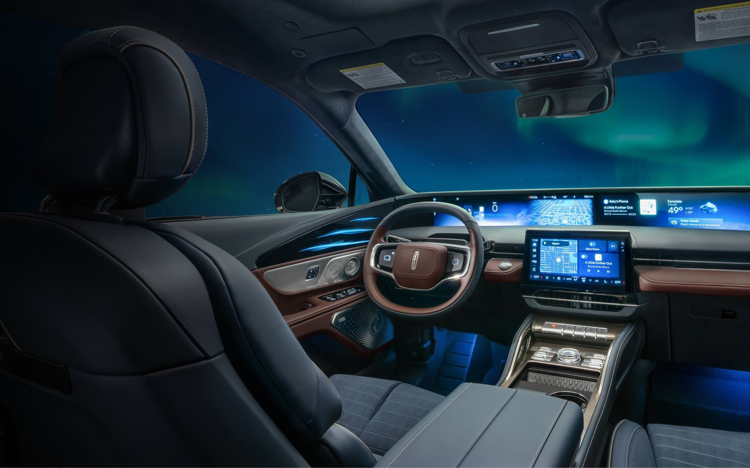 The northern light light up the night sky as seen through the windshield of a 2026 Lincoln Black Label™ Nautilus® SUV with the Aurora interior theme