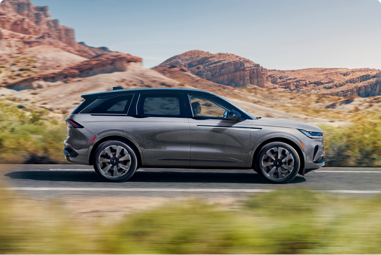 The 2025 Lincoln Nautilus® SUV on a remote road with mountains in the background