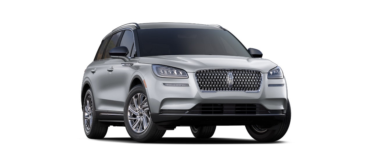 A front three quarter shot of a 2021 Lincoln Corsair in Silver Radiance highlights the signature Lincoln grille and L E D headlamps