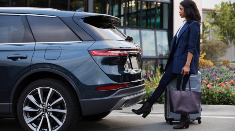 Woman using hands free foot activated liftgate on rear of 2020 Lincoln Corsair