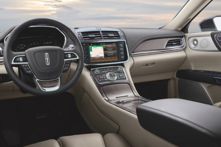 Interior of new Lincoln vehicle which shows the steering wheel and front dashboard.