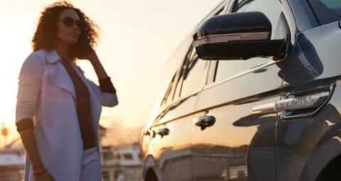 Woman carrying purse approaching 2021 Lincoln Navigator Reserve