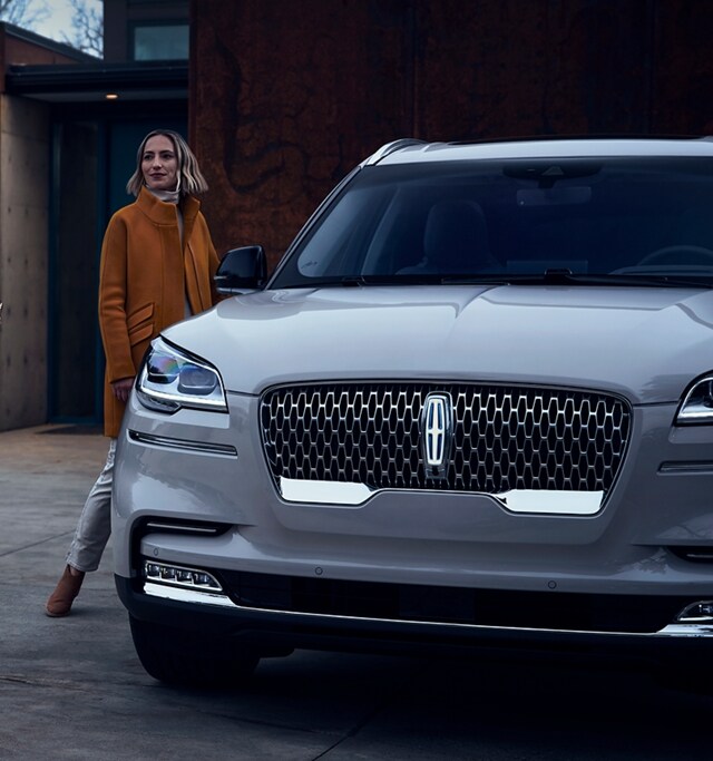 a woman approaching a Lincoln Aviator is shown here