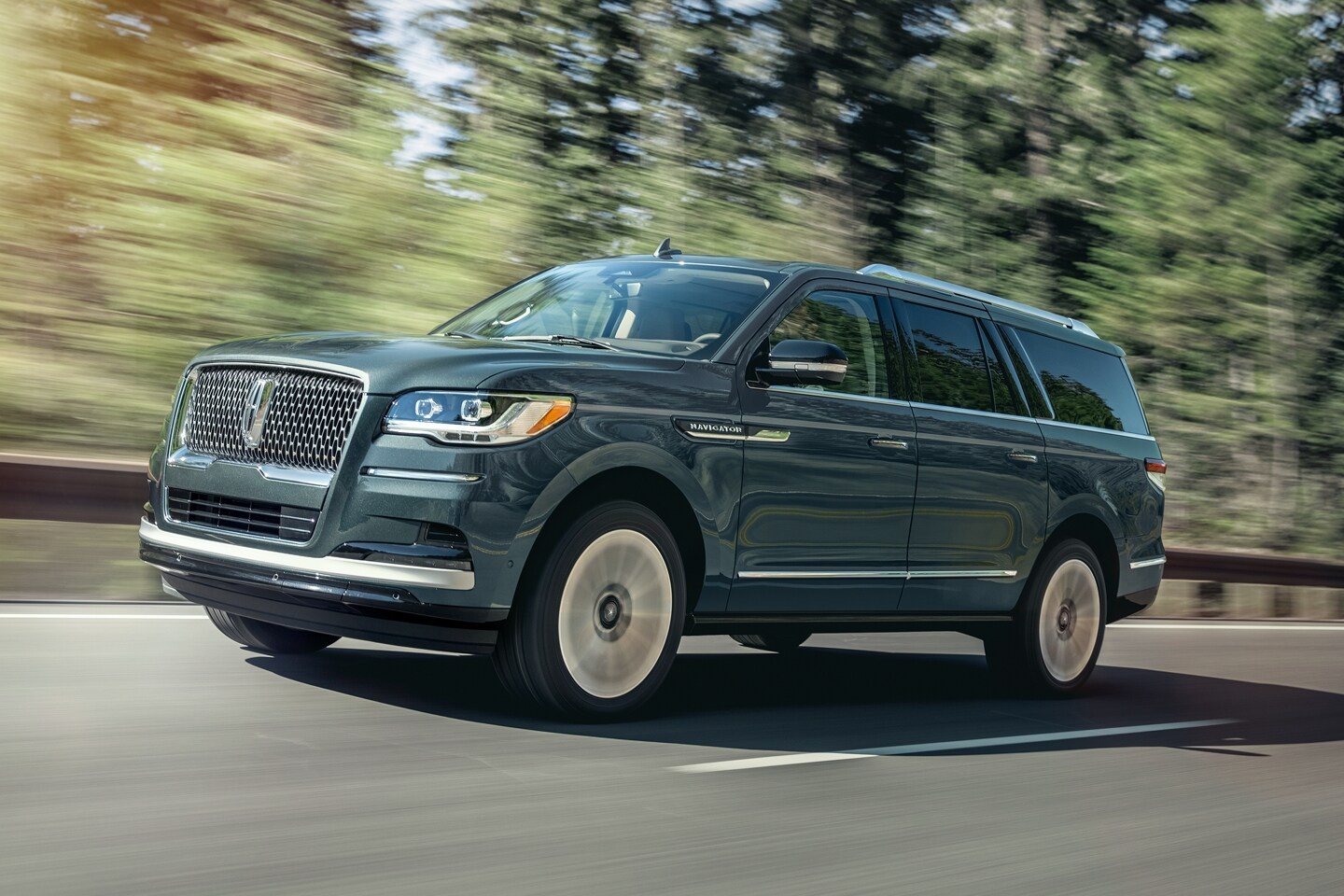 The 2023 Lincoln Navigator driving on a road.
