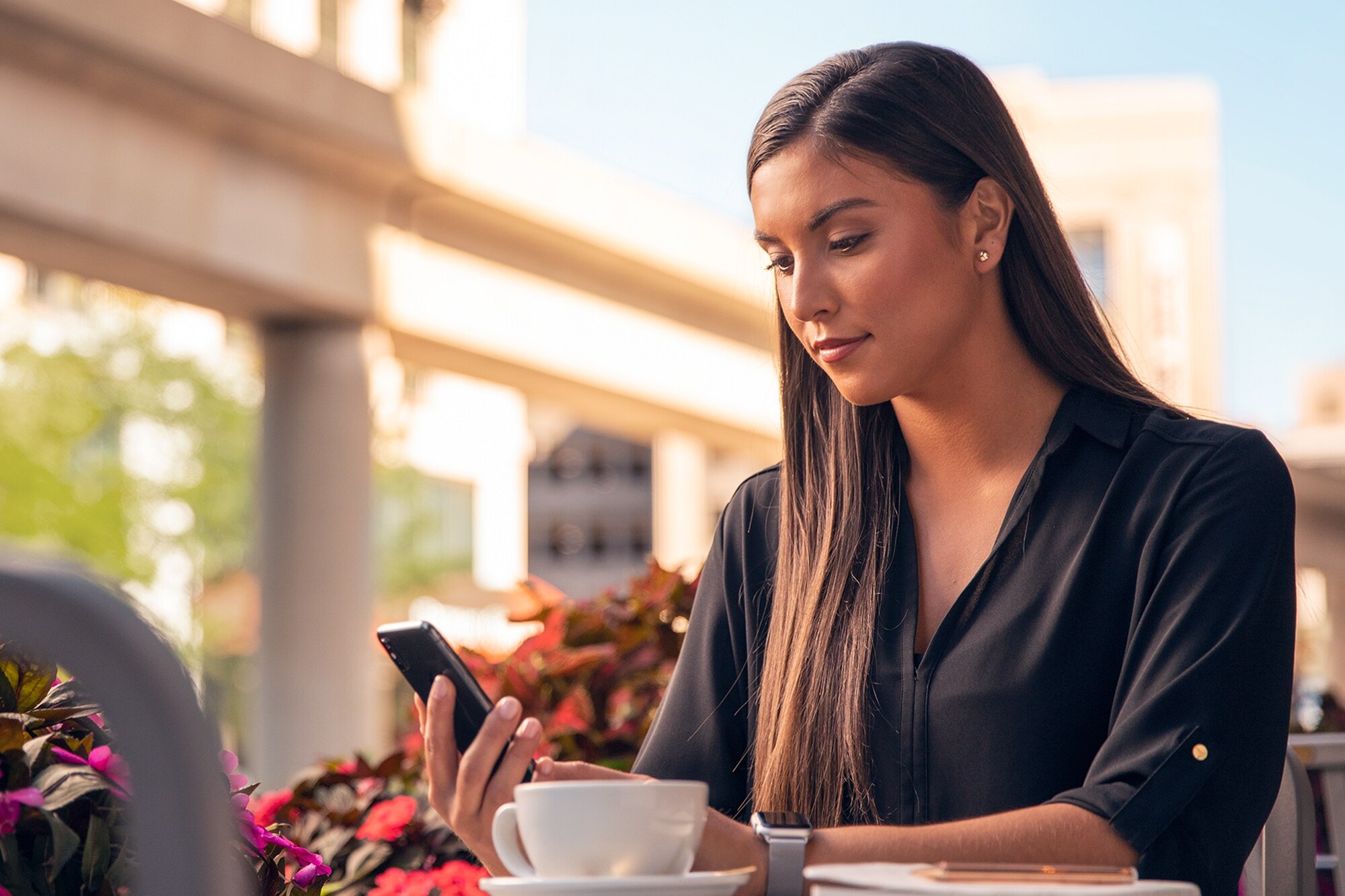 A woman outside checking her phone.