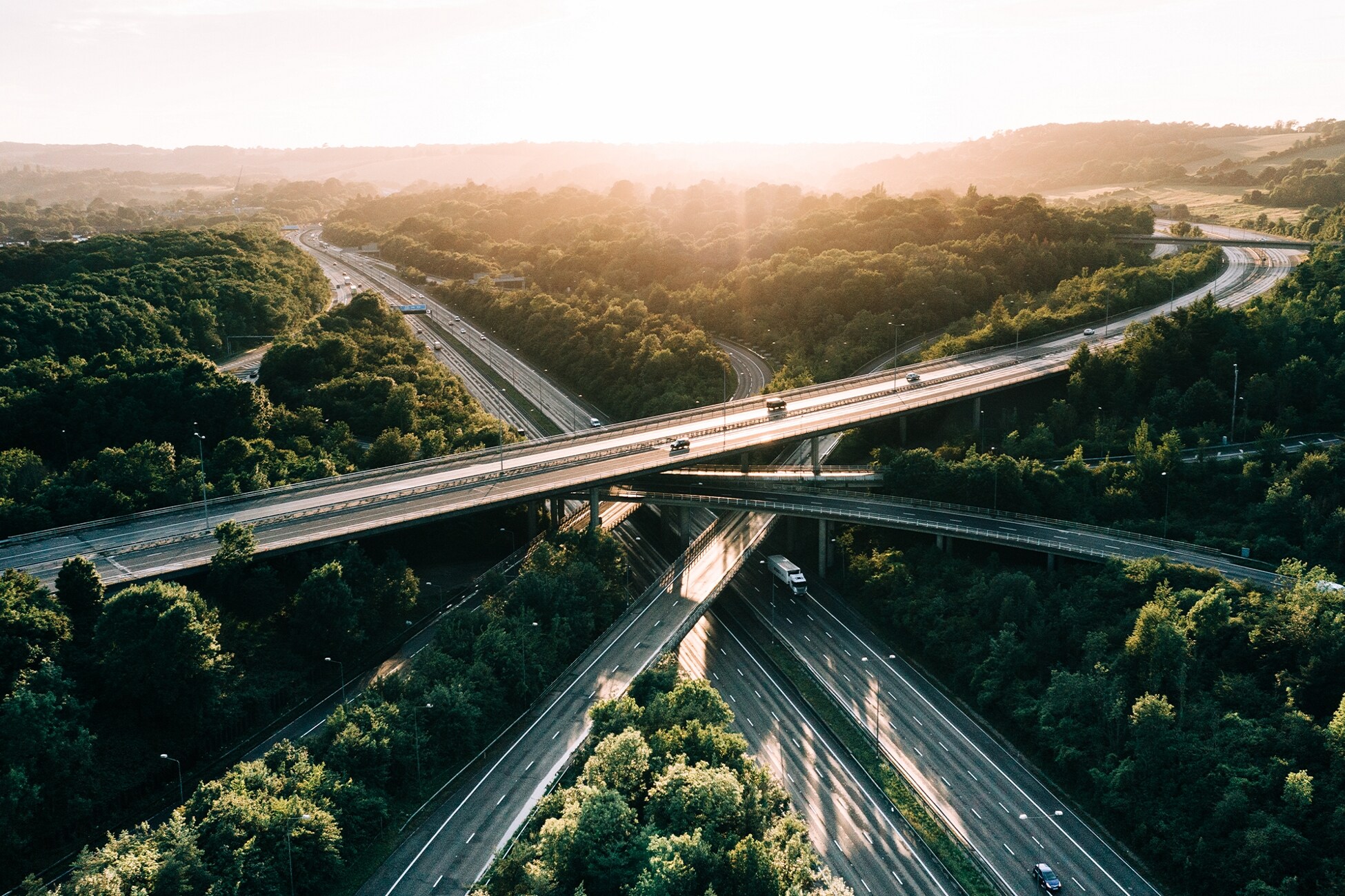 Cars travelling on many different roads that are intertwined.