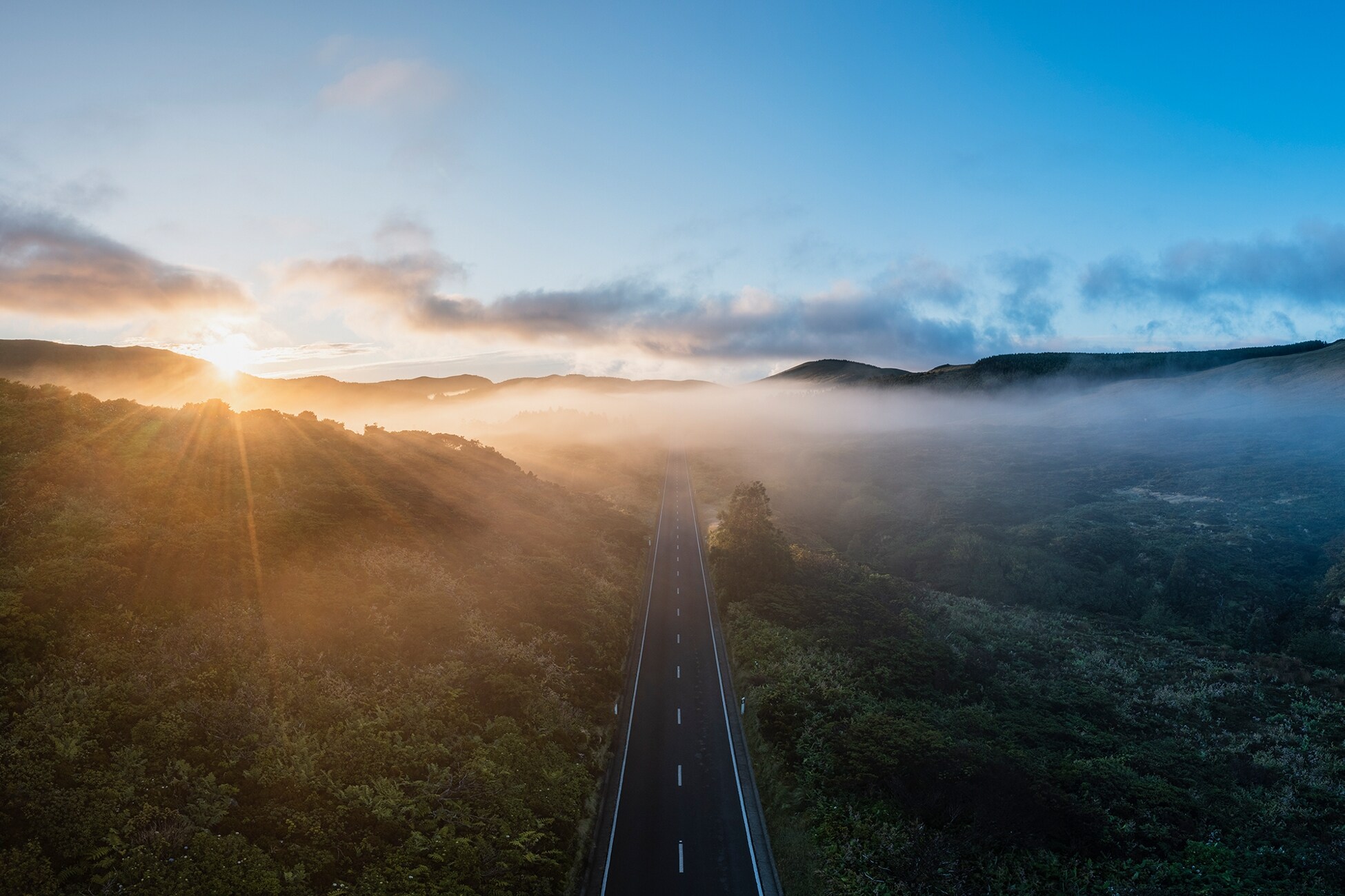 A scenic road leading into a sunset.