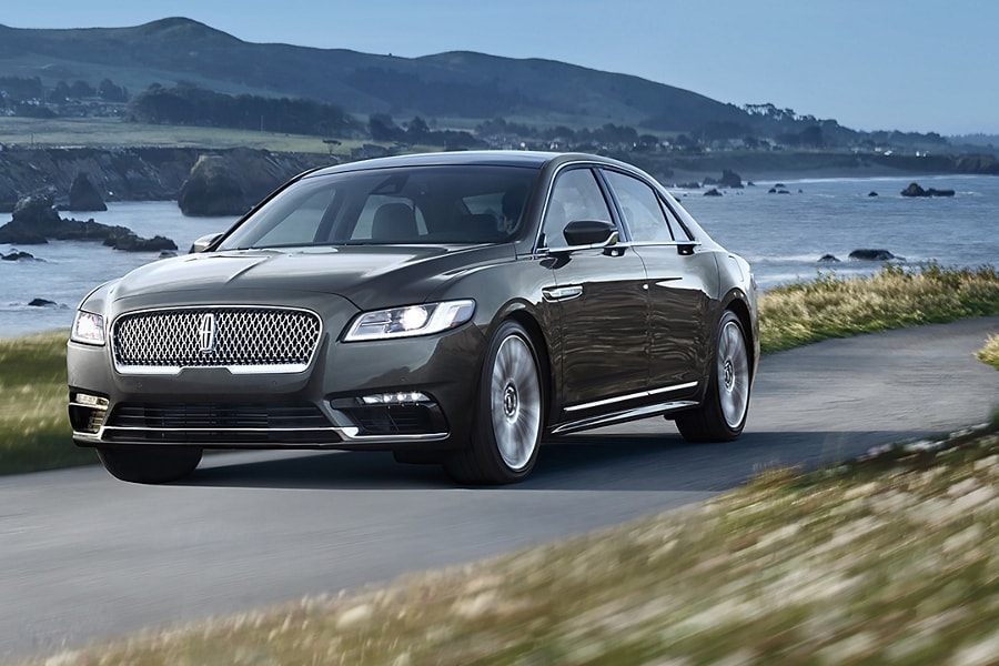 A Lincoln Continental is being driven up an incline along a mountain side