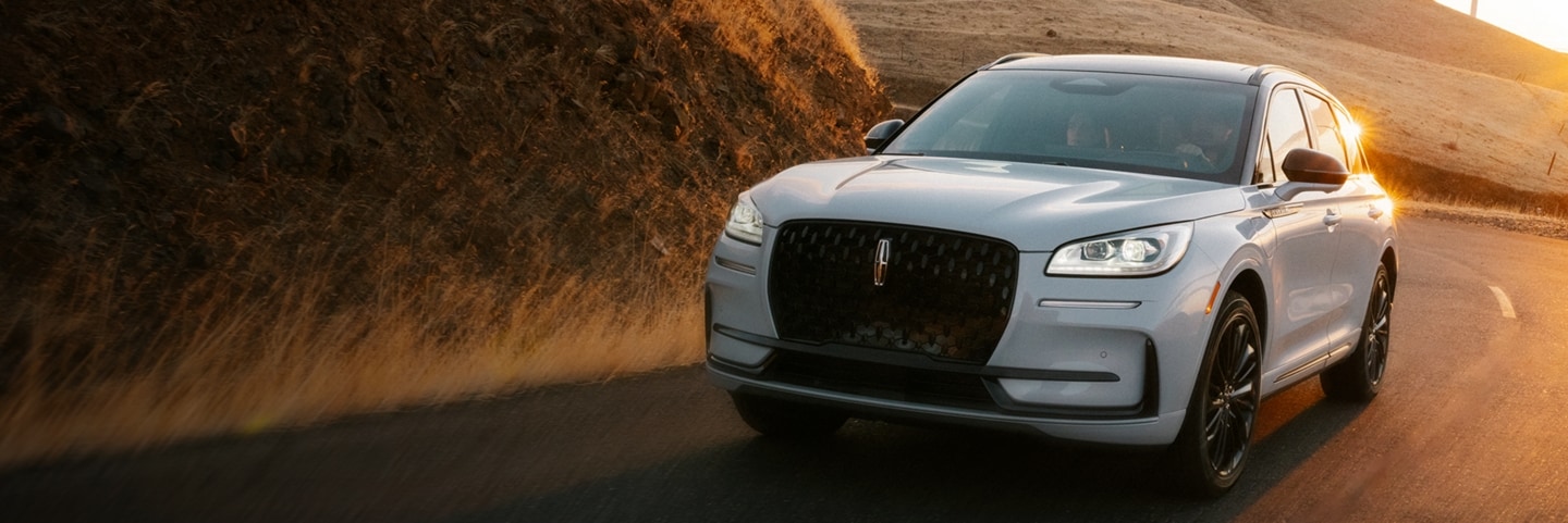 The Lincoln Corsair driving down a curvy road.