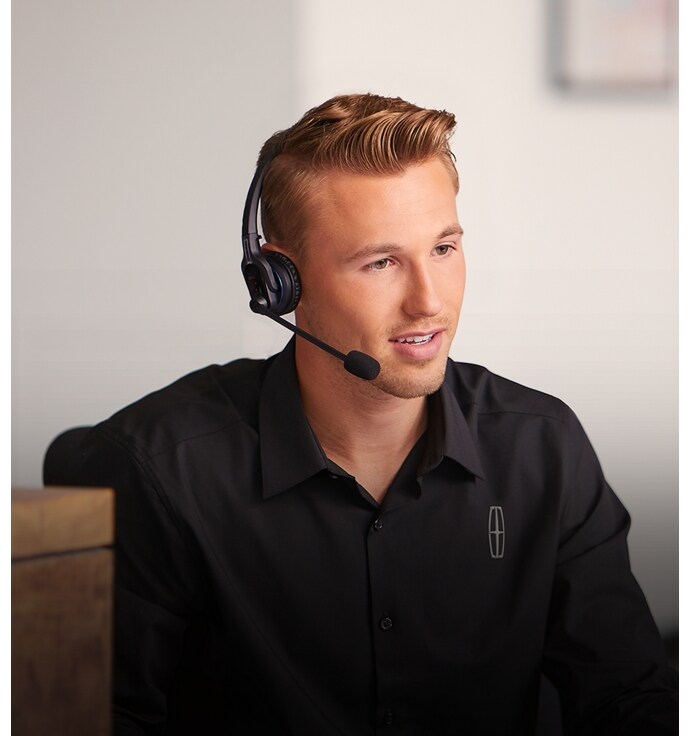 A photo of a Lincoln employee working at the Client Relationship Center.