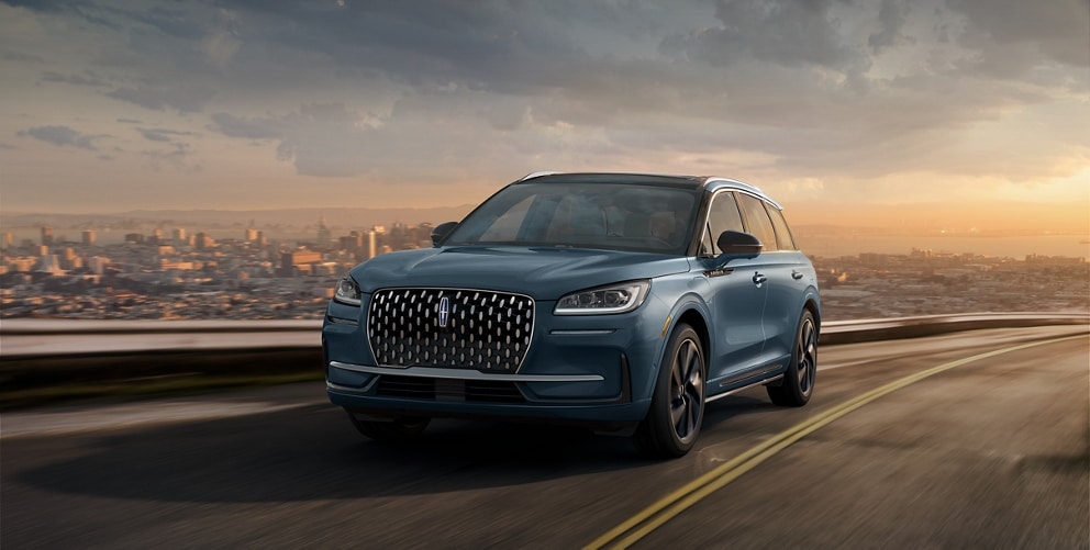 A 2023 Lincoln Corsair® Grand Touring SUV is being driven on a hillside road