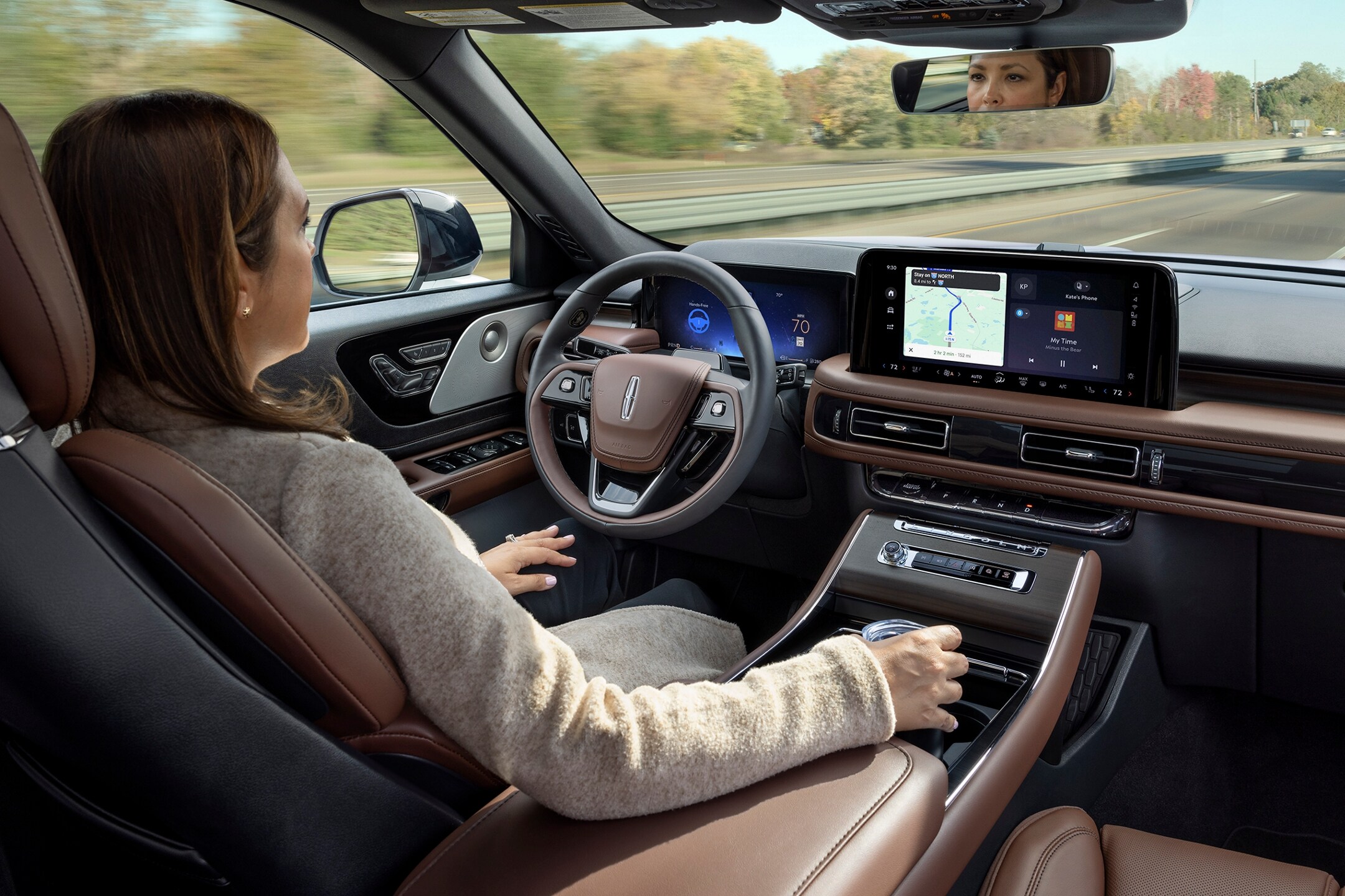 A woman sitting inside the Lincoln Aviator using the BlueCruise functionality.