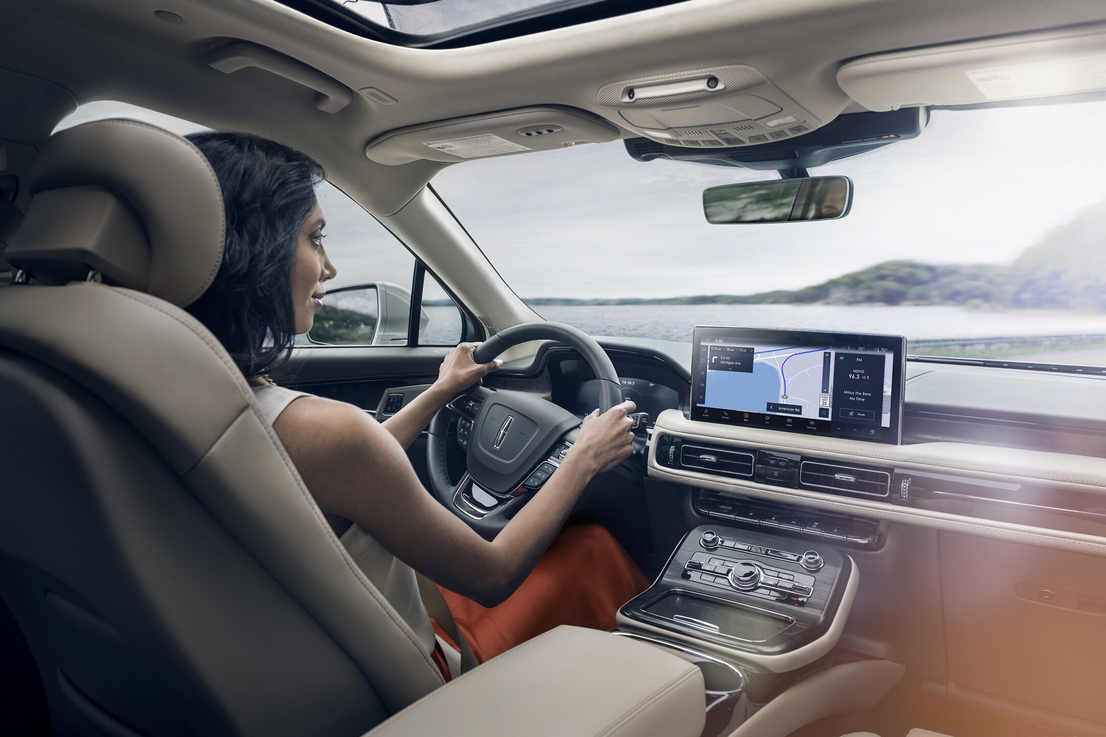 A woman driving the Lincoln Nautilus.